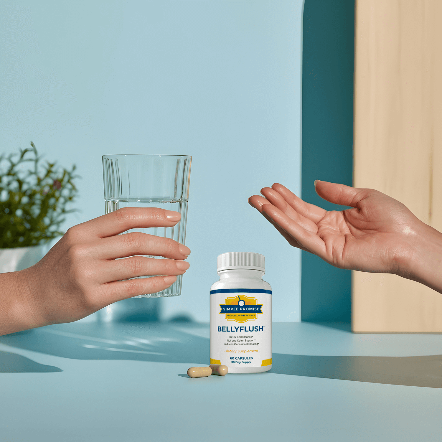 Hands holding a glass of water beside a BellyFlush bottle